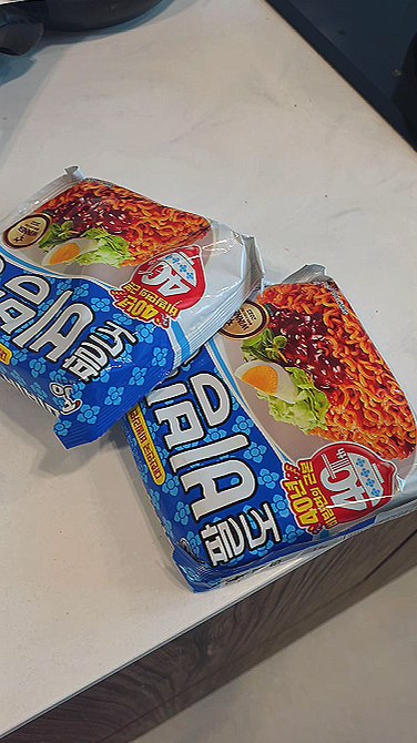 Two packets of Paldo Bibimmyeon on the counter