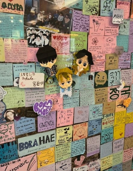 A wall covered in handwritten ARMY fan letters at Hyuga Cafe, BTS's former dorm in Seoul