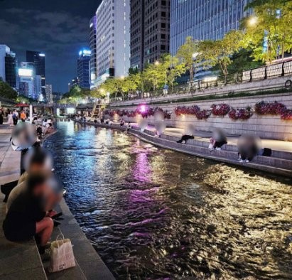 Cheonggyecheon at night, the stream and stepping-stones lit up in central Seoul