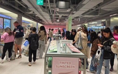 Tinted sunscreen display in an Olive Young store.