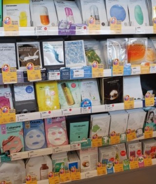 Shelves of assorted sheet masks with individual price labels.