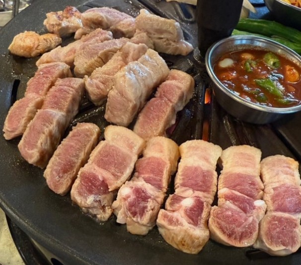 Thick-cut fresh saeng-samgyeopsal showing the striped layers of meat and fat in Korean pork belly