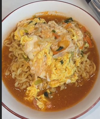 A finished bowl of Samyang Ramen cooked the restaurant way, with an egg in the broth