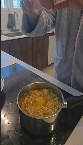 Cracking a whole egg into the pot of ramyun