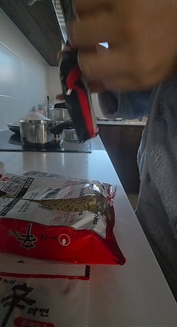 A packet of Shin Ramyun on the counter while water heats